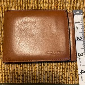Coach wallet, brown. Used. Leather is stretched out. 3 Card slots, 1 photo slot